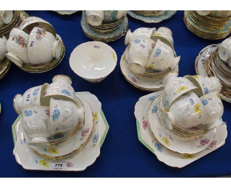 A Shelley porcelain teaset decorated with pink, blue and yellow poppies, comprising two cake plates, twelve plates, saucers, 