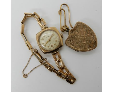 A 9ct gold ladies vintage watch, weight including mechanism 14gms and a yellow metal locket Condition Report: Available upon 