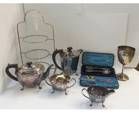 A lot comprising an EP cakestand, a four piece tea service, a goblet, a cased pair of spoons and a cased three piece christen