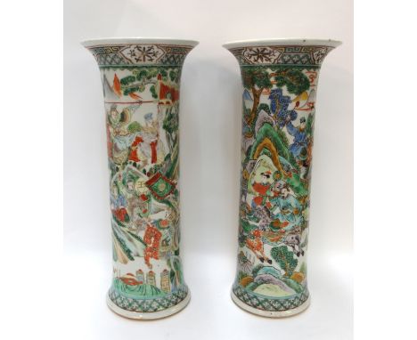 A pair of Chinese cylindrical vases painted with scenes of figures in green, orange and blue, 36cm high Condition Report: One