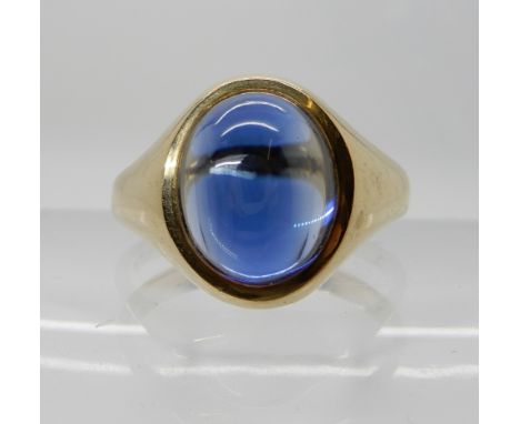 A 9ct gold signet ring set with a faux sapphire, finger size S1/2, weight 4.8gms Condition Report: Available upon request