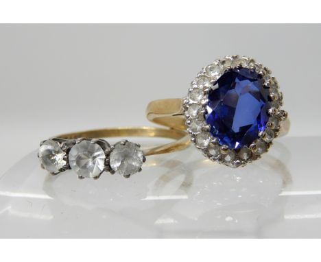 A 9ct gold blue gem and clear gem cluster ring, size M and a 9ct and silver three stone clear gem ring P, weight approx 4.5gm