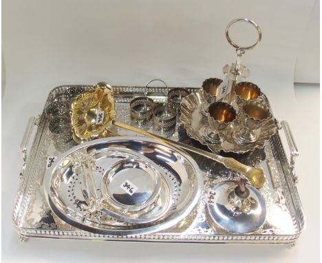 A lot comprising a plated egg cruet, taper burner, punch ladle, knife rests, napkin rings and a double handled tray Condition
