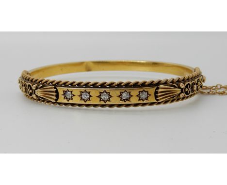 A 15ct gold and diamond set Etruscan revival designed bangle, weight approx 10gms Condition Report:A dent to the interior beh