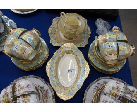 A Plant Tuscan teaset, the gold wriggle work ground with pale blue and lemon flowers, comprising twelve plates, eleven saucer