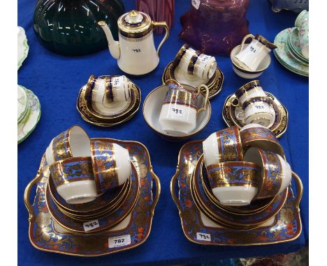 A Noritake teaset, with blue band decorated with gilt and orange flower decoration on white ground, a Royal Albert coffee cup