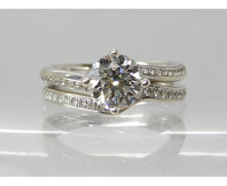 An 18ct white gold diamond solitaire with diamonds set to the shoulders, main diamond estimated approx 0.75cts, finger size M
