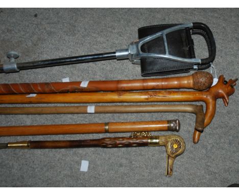 A modern decanter walking cane, shooting stick, other canes, shoe horn Condition Report: Available upon request