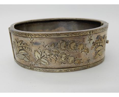 A wide silver vintage floral bangle Condition Report: Available upon request