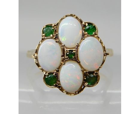 A 9ct gold white opal and emerald cluster ring, finger size V1/2, weight 4.6gms Condition Report: Available upon request