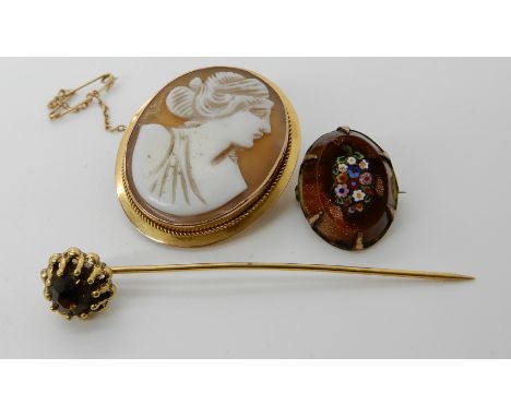 A 9ct gold cameo brooch, a goldstone millefiori inlaid gold plated brooch and a yellow metal pin Condition Report: Available 