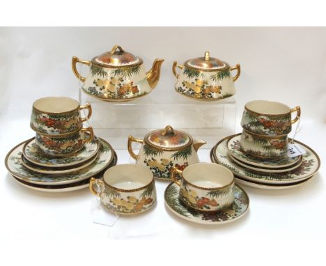 A Japanese Satsuma teaset, decorated with flowers, comprising; teapot, milk jug, sucrier, six cups, five saucers and four pla