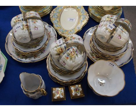 A Noritake hand painted teaset, painted with roses and other flowers on a white ground, comprising two cake plates, eight pla