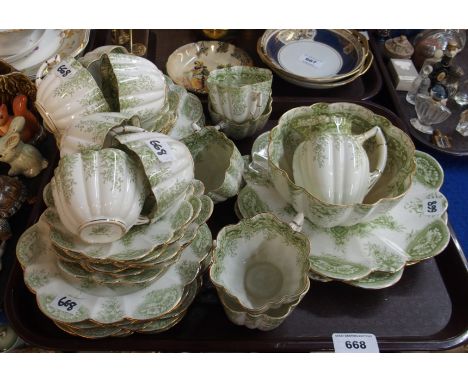 A Wileman Foley China teaset with green transfer printed decoration Condition Report: Two cake plates - rubbing to glaze on r