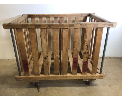 A Factory bobbin cart, for use as a log or laundry basket. W:110cm x D:70cm x H:83cm.
