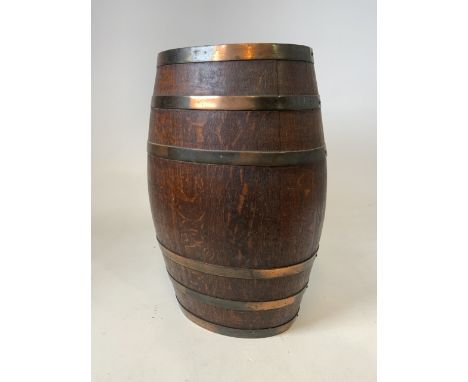 An oak oval coopered barrel stick stand with six compartments. With badge manufactured by Lethbridge cooperage Plymouth.W:40c