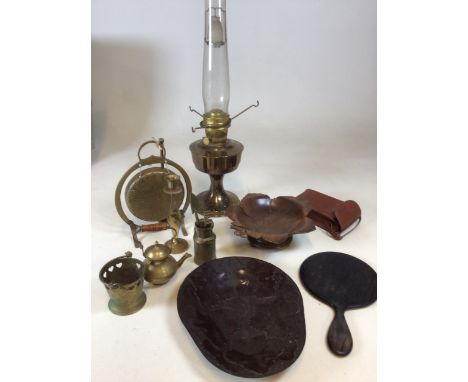 A brass Aladdin lamp together with a Swiss wooden carved musical dish, an early plastic moulded plate with leaf pattern, bras