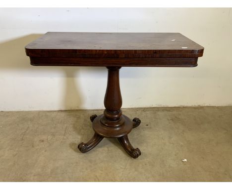 A Victorian rosewood folding card table on large turned pedestal base. W:92cm x D:46cm x H:74cm