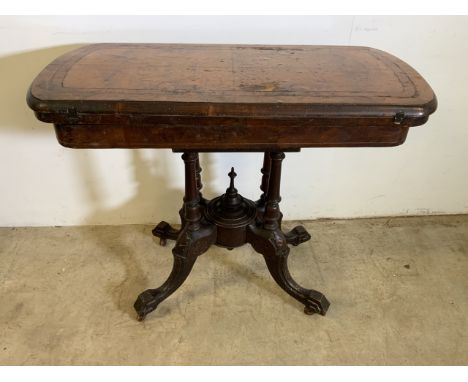 A walnut veneered Victorian card table with bird cage pedestal, brass and ceramic castors. W:90cm x D:45cm x H:72cm