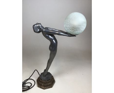 An Art Deco style figural lamp of a nude holding a glass ball. Cast aluminium on stepped plinth. Height of lady 55cm 