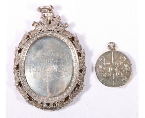 Un-hallmarked silver medal awarded to Ronald McKenzie for Pibroch playing 1877 of 78th Highlanders presented by Robert McNab 