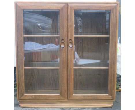 Ercol mid 20th century oak two door glazed display cabinet/bookcase. Approx. 97cms H x 91cms W x 29cms D 