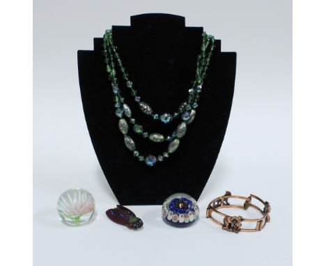 Collection of costume jewellery to include a vintage cicada brooch, coloured beads, bangle and two small glass paperweights (