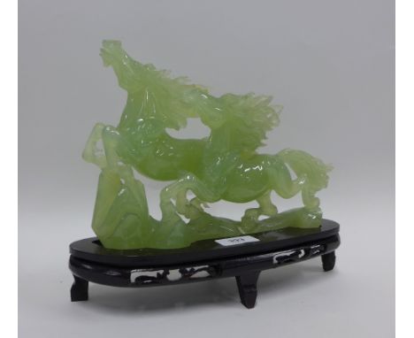 Jade carving of a horse on wooden stand, (repair to ear) 28cm long 