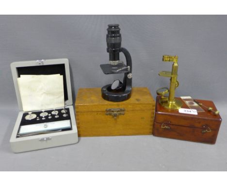 Small brass microscope, 12cm, with its mahogany fitted box, a black enamel microscope by Baker, London and a box of Stanton I