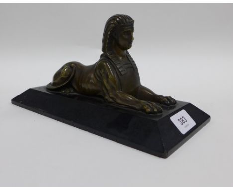 Bronze Egyptian sphinx on a black hardstone base, 26cm 