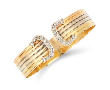 DIAMOND BANGLE in C de Cartier style, set with round cut diamonds in C logos terminating the tri colour gold band,, 6cm inner