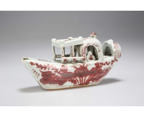 A CHINESE UNDERGLAZE RED AND WHITE PORCELAIN WATER DROPPER, KANGXI/ YONGZHENG PERIOD modelled in the form of figures within a