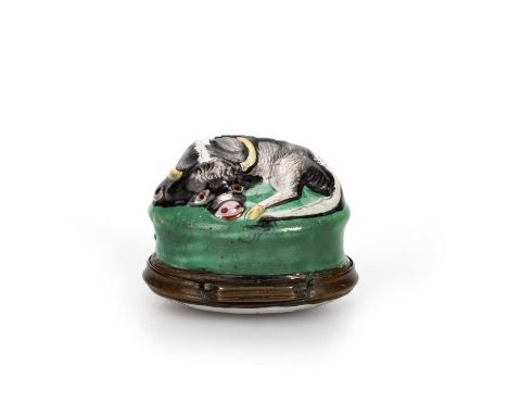 A SOUTH STAFFORDSHIRE ENAMEL COW BONBONNIÈRE, CIRCA 1770 modelled as a bull, lying on a green grassy mound, the hinged cover 