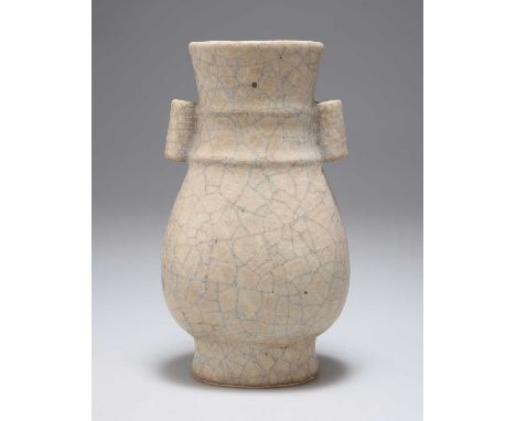 A CHINESE SONG-STYLE GUAN-TYPE HU-SHAPED VASE with arrow slots and a flattened ovoid body, the base with twin holes. 18cm hig