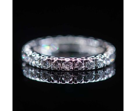 A PLATINUM AND DIAMOND ETERNITY RING unmarked, set with round brilliant-cut diamonds in claw-settings. Ring size K1/2, 4.4 gr
