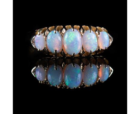 A VICTORIAN 18 CARAT GOLD OPAL RING with five claw-set graduated cabochon opals, marks rubbed. Ring size P1/2, 3.5 grams gros