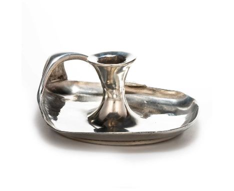 ARCHIBALD KNOX (1864-1933) FOR LIBERTY & CO, A TUDRIC PEWTER CHAMBERSTICK the shaped dish with bifurcated handles and taperin