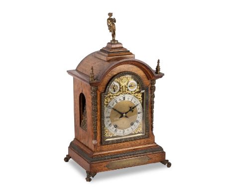 A WINTERHALDER & HOFMEIER OAK BRACKET CLOCK, CIRCA 1890 the arch-top surmounted by a cast Classical figure, the gilt 7-inch b