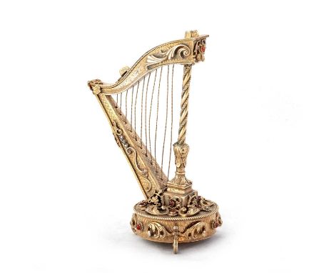 AN AUSTRIAN SILVER-GILT MODEL OF A HARP Vienna, c.1890, with applied and engraved scroll decoration, set with pearls and red 