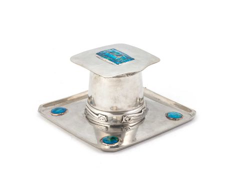 ARCHIBALD KNOX (1864-1933) FOR LIBERTY & CO, A TUDRIC PEWTER AND ENAMEL INKWELL  mounted on a square base with a circular dis