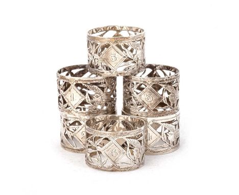 A SET OF SIX VICTORIAN SILVER NAPKIN RINGS by Daniel &amp; John Wellby, London 1880, in the Aesthetic taste, each circular ri