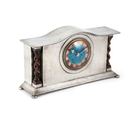 A LIBERTY & CO TUDRIC PEWTER MANTEL CLOCK the hammered pewter case with a blue/ green shaded enamelled copper dial, unusually