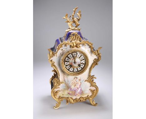 A SÈVRES STYLE ORMOLU MOUNTED MANTEL CLOCK, 19TH CENTURY of Rococo design with gilt ormolu foliate mounts and finial, the 9.5
