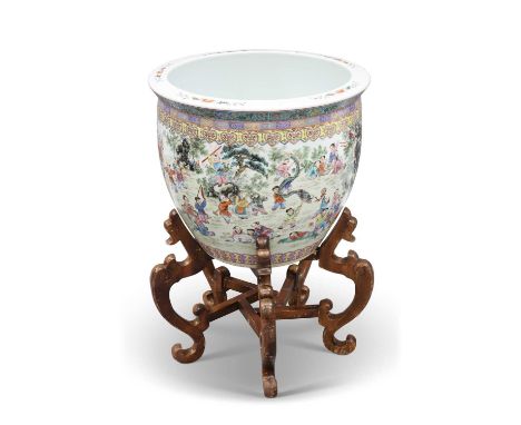 A LARGE CHINESE FAMILLE ROSE FISH BOWL ON STAND enamel painted with figures, on a wooden stand. Bowl 55cm high, 47cm diameter