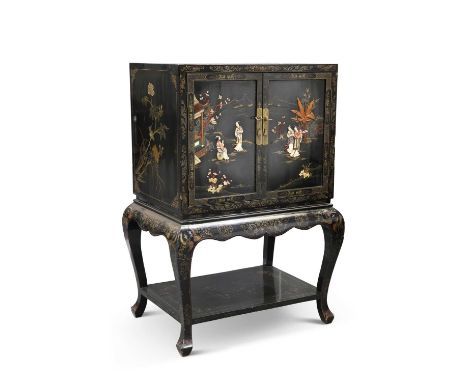 A CHINESE LAQUER CABINET the cabinet with a pair of panel doors decorated front and back with figures, raised on cabriole leg