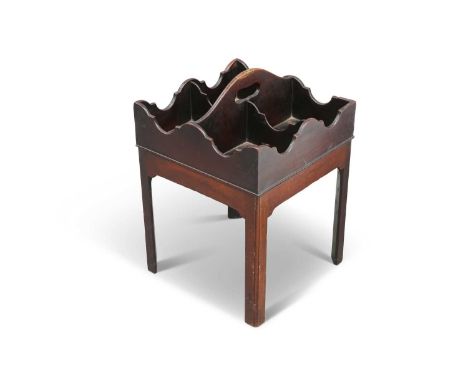 A GEORGE III MAHOGANY DECANTER STAND square, the tray top with carrying handle and four sections for decanters, raised on cha