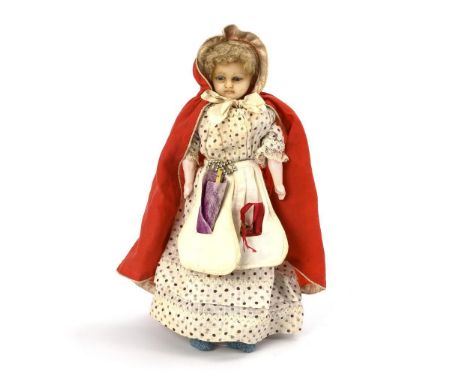 Kleine Wachspuppe als Schneiderin. Um 1880. Thüringen.             Wachs, Stoff, Masse. L 30 cm.             Stark wachsierte