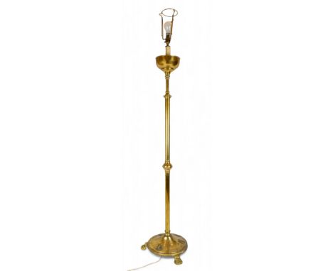 An extendable brass floor lamp, on claw feet  Dimensions: 64 in. (H)