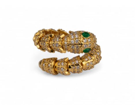 Continental, Contemporary A diamond and 18 carat yellow gold snake ring. Set with cabochon emerald eyes.  Finger size: P-R We