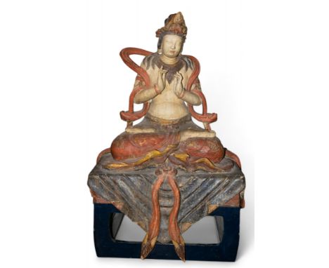 Chinese 18th Century or earlier A large and rare carved painted wood figure of Kuan Yin, the Bodhisattva of mercy, seated cro